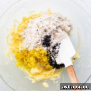 Lemon Poppy Seed Shortbread 7 A bowl of dough ingredients with a wooden spoon.