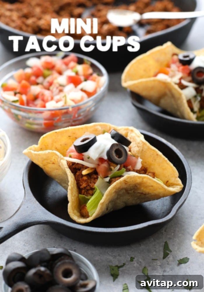 Delicious mini baked taco cups on a rustic plate, ready to be enjoyed with fresh ingredients.