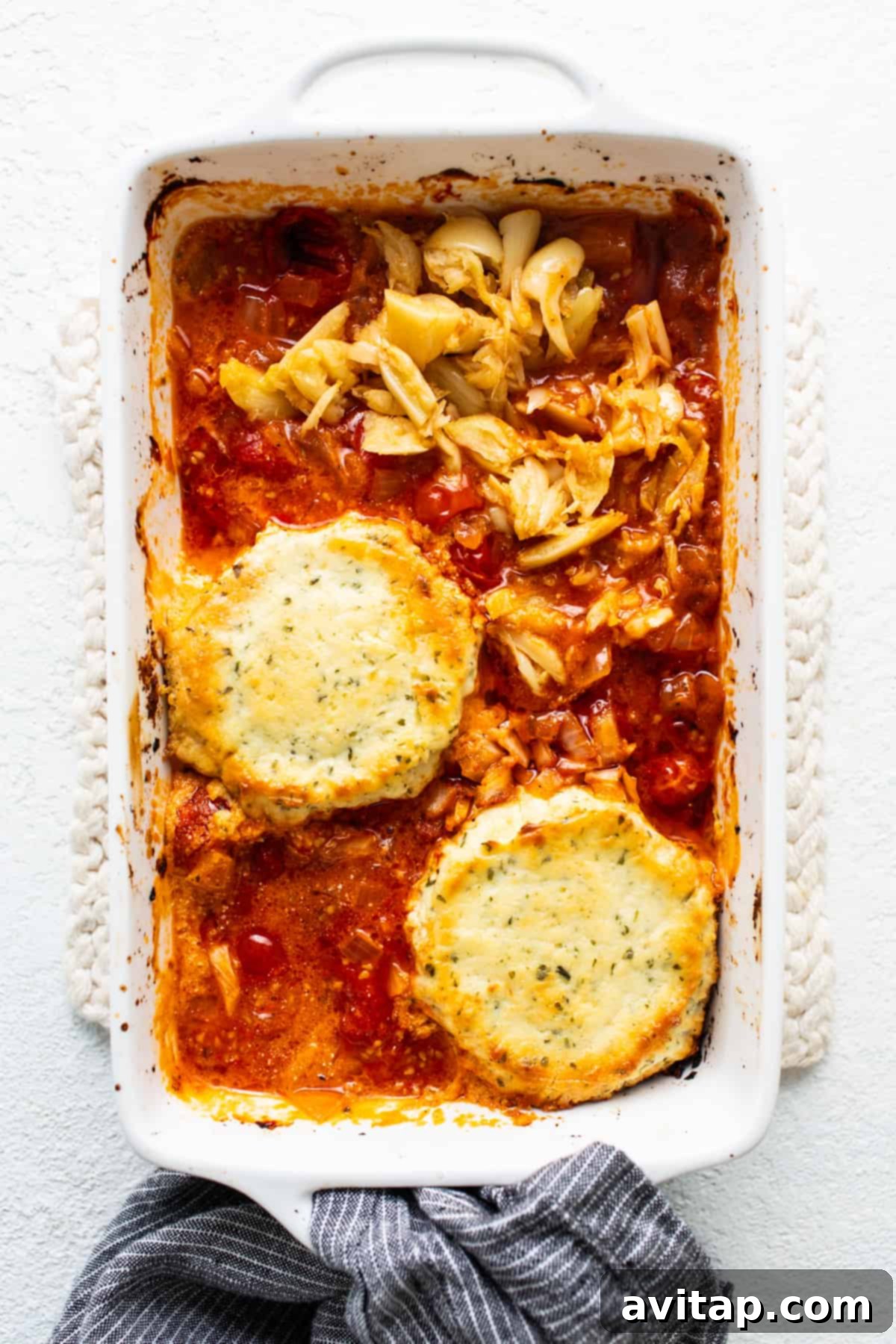 Creamy Roasted Garlic Boursin Bake 5 A casserole dish with creamy pasta and roasted vegetables, suggesting a meal made from the dip.