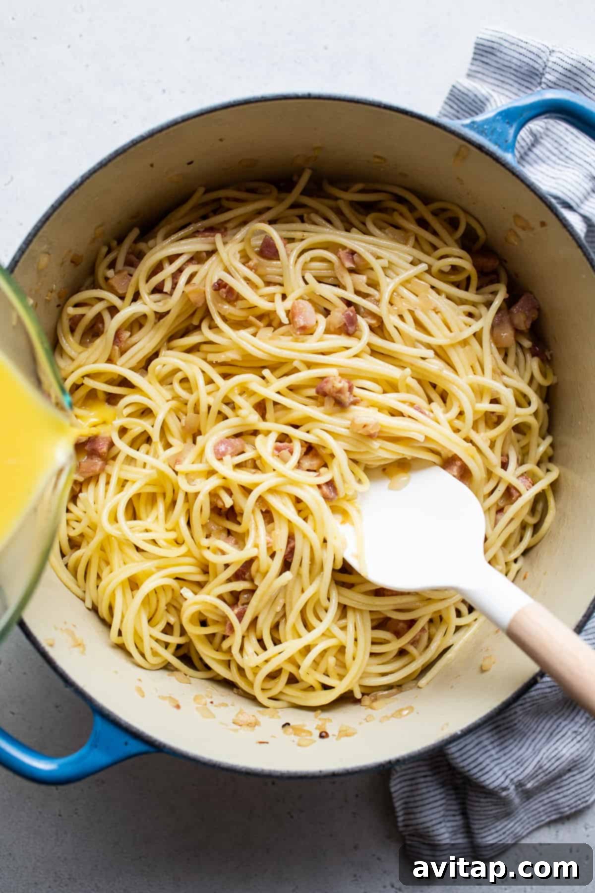 Easy Weeknight Carbonara 4 Pancetta cooking in a blue Dutch oven, ready for spaghetti.