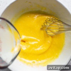 Easy Weeknight Carbonara 9 A bowl of yellow liquid with a whisk in it.