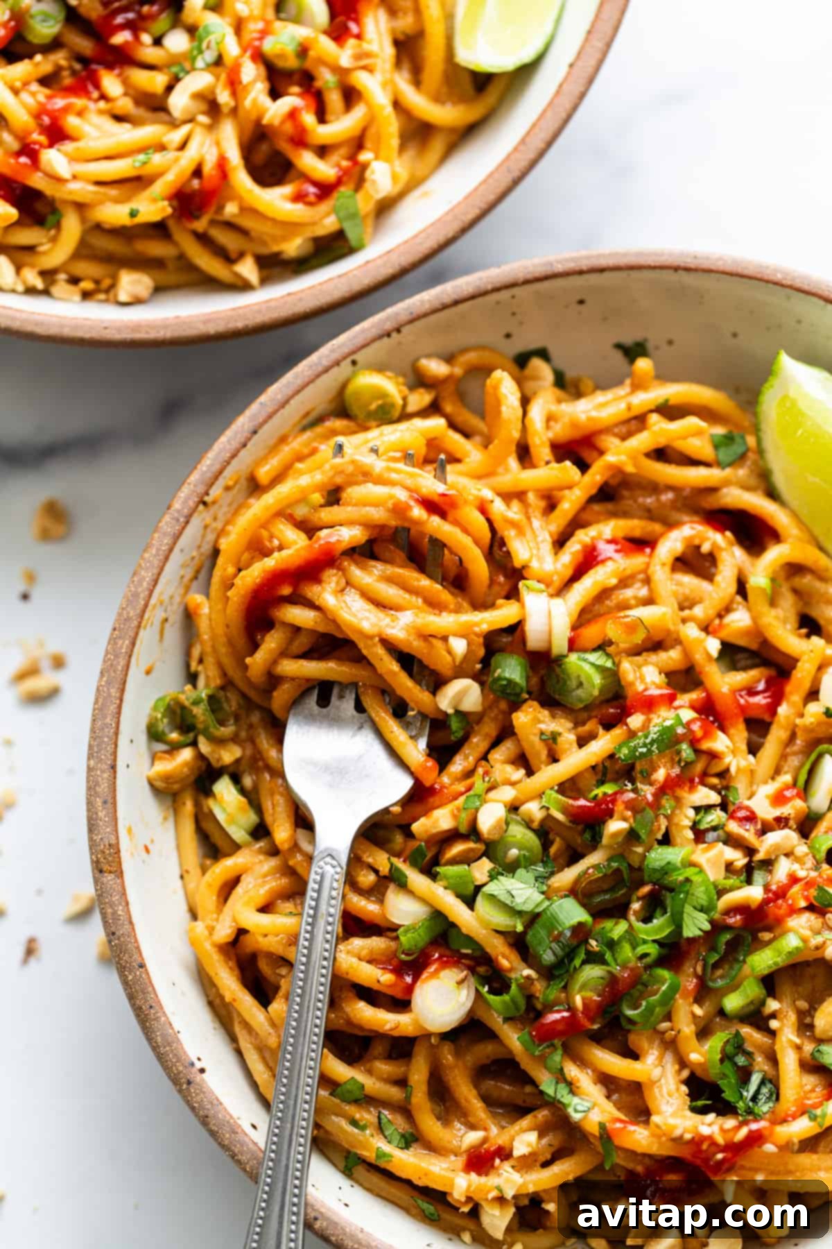 Quick Peanut Noodles in 20 Minutes 5 Two bowls of noodles with peanut sauce and lime.