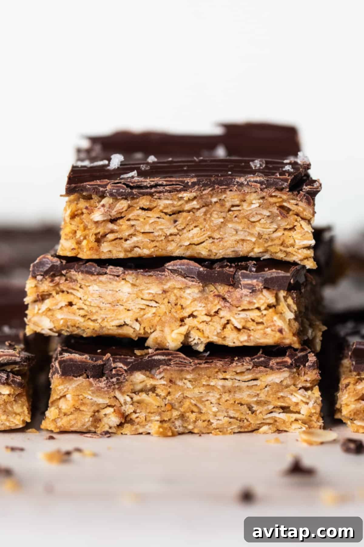 Ultimate Peanut Butter Cup Oatmeal Bars 2 A stack of delicious chocolate peanut butter oatmeal bars, beautifully layered and ready to eat.