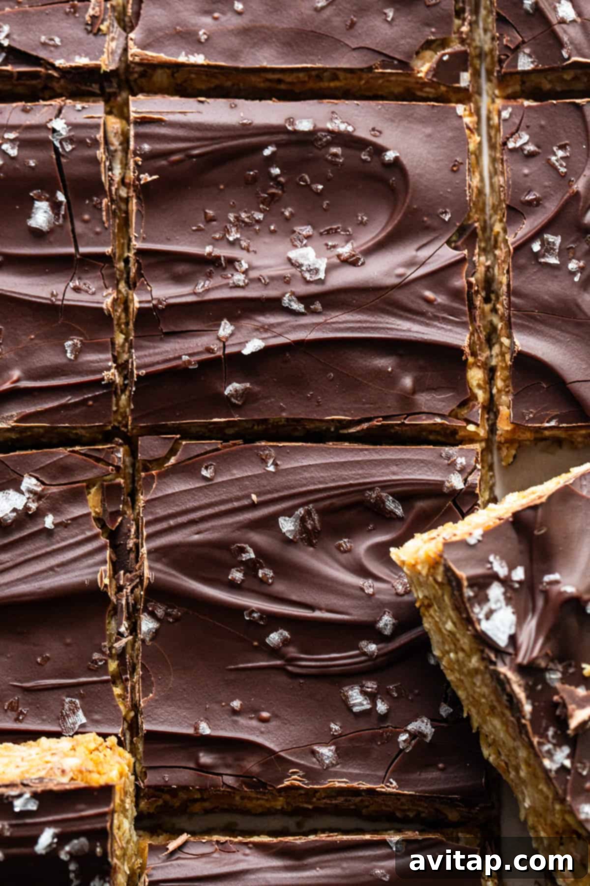 Ultimate Peanut Butter Cup Oatmeal Bars 7 A close-up of the rich, melted chocolate layer, enticing and ready to be topped with sea salt.