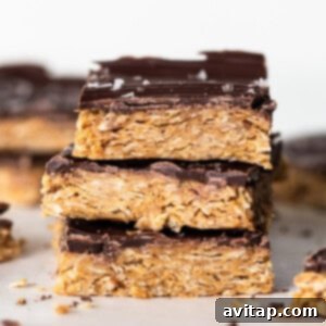 A stack of delicious chocolate peanut butter granola bars, showcasing their layers and textures.