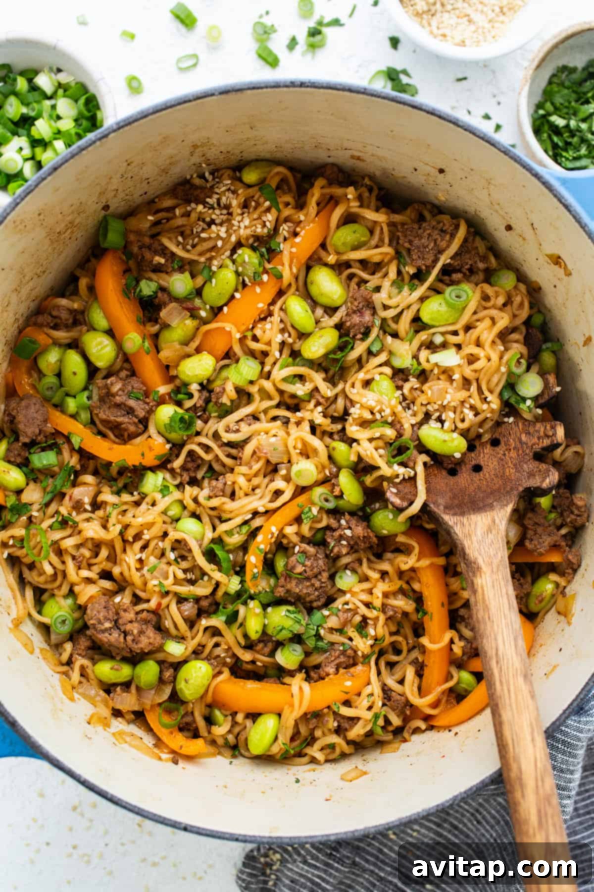 A vibrant close-up of a bowl of one-pot ground beef ramen noodles, featuring a rich broth, tender beef, and crisp bell peppers, ready to be enjoyed.