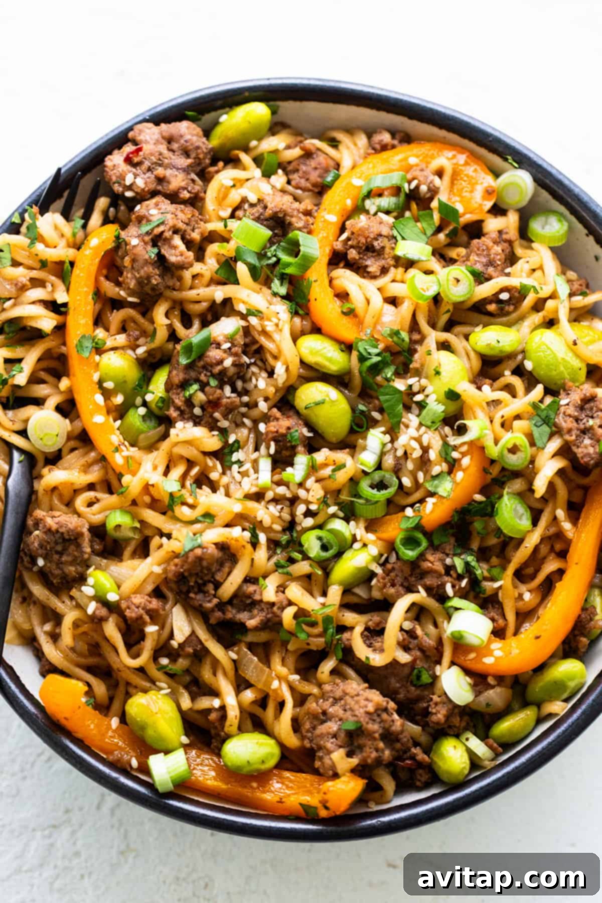 A hearty serving of one-pot ground beef ramen noodles in a bowl, showing the delicious combination of ground beef, colorful vegetables, and tender noodles.