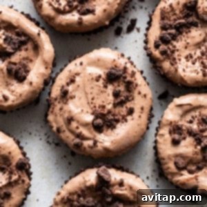 Finished chocolate mousse cups, garnished with chocolate chips and cocoa powder, arranged beautifully for serving.
