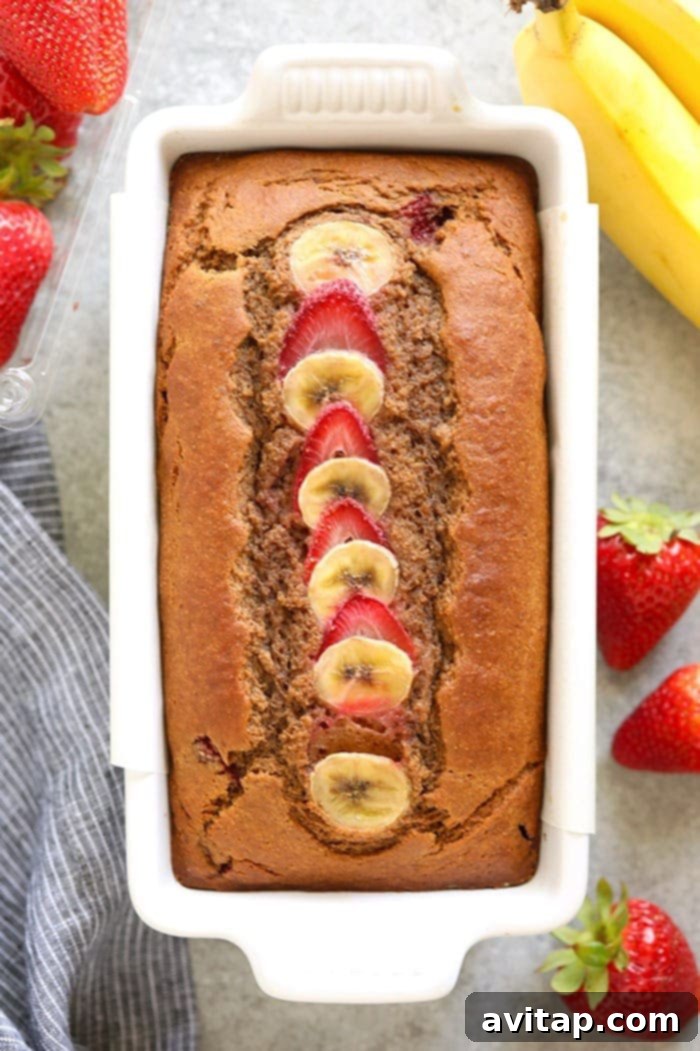 Effortless Strawberry Banana Bread 5 A freshly baked loaf of strawberry banana bread cooling on a wire rack.