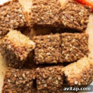 Carrot bars with oats and carrots on a cutting board, ready to be sliced.