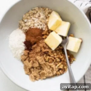 Oats, cinnamon, butter and sugar in a bowl, ingredients for streusel.
