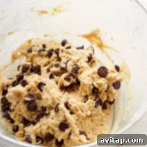 Chocolate chip cookie dough in a bowl, perfectly mixed and ready to be scooped.