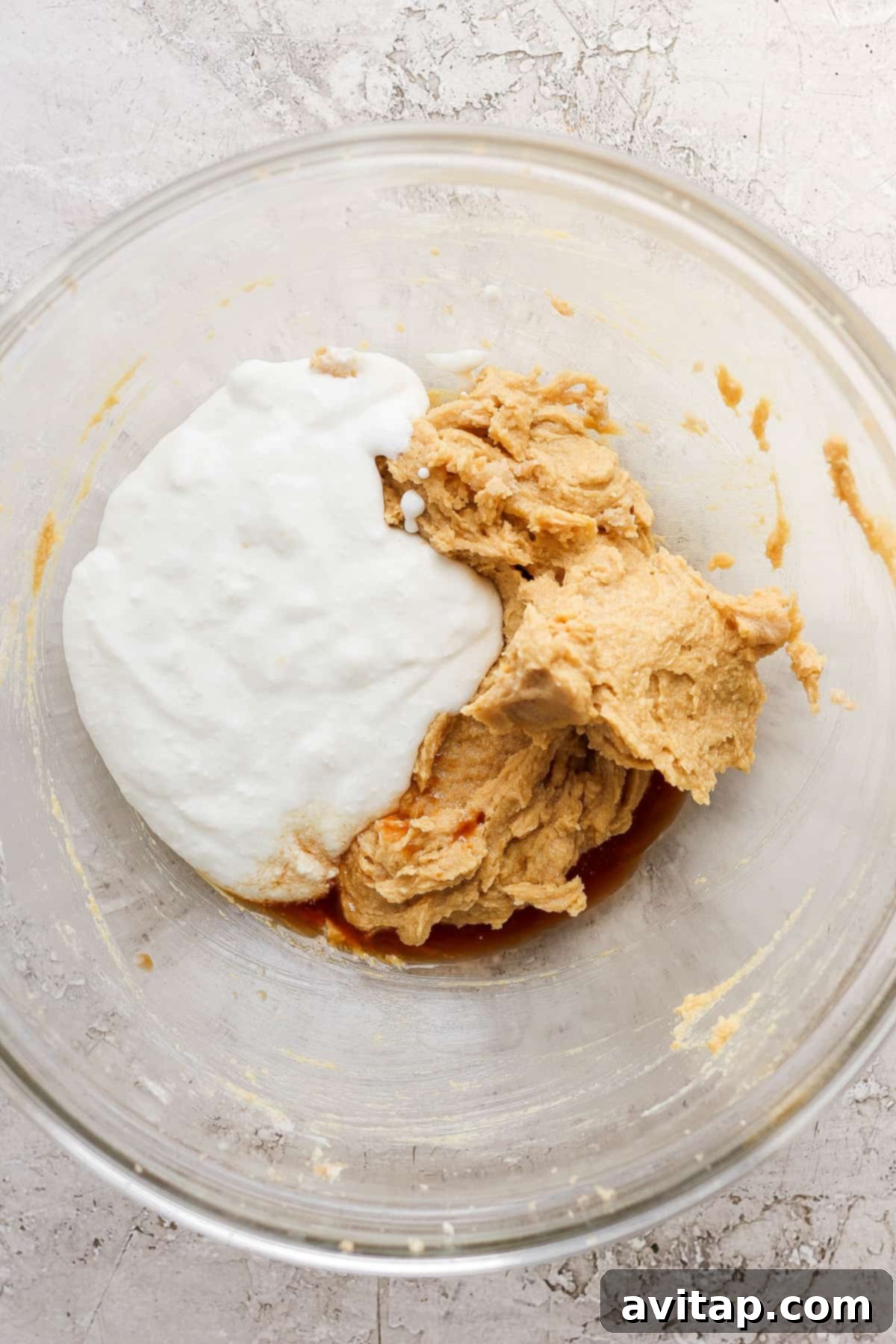 All the fresh ingredients for baking high-protein cottage cheese chocolate chip cookies are neatly arranged on a kitchen counter.