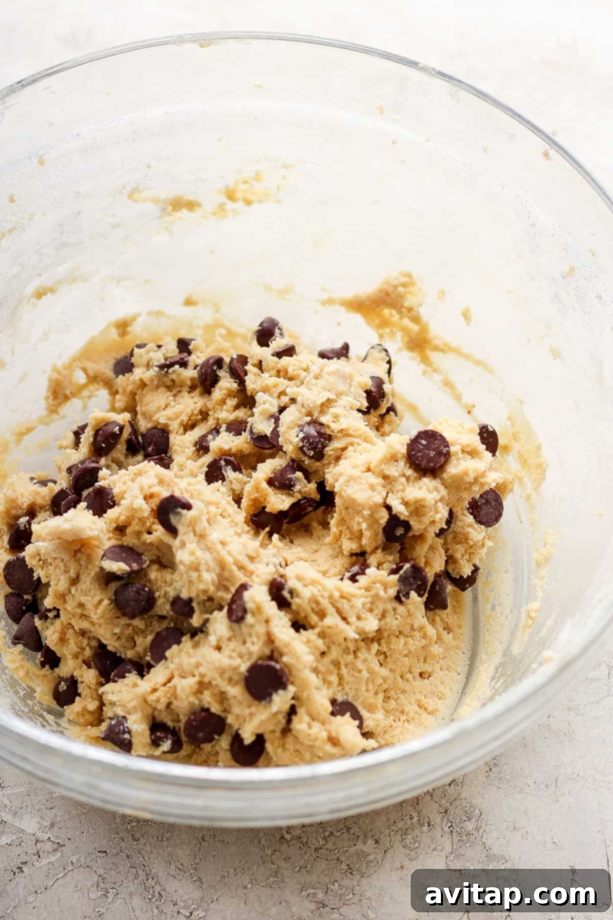 Rich, perfectly mixed chocolate chip cookie dough in a bowl, showcasing its readiness for baking.