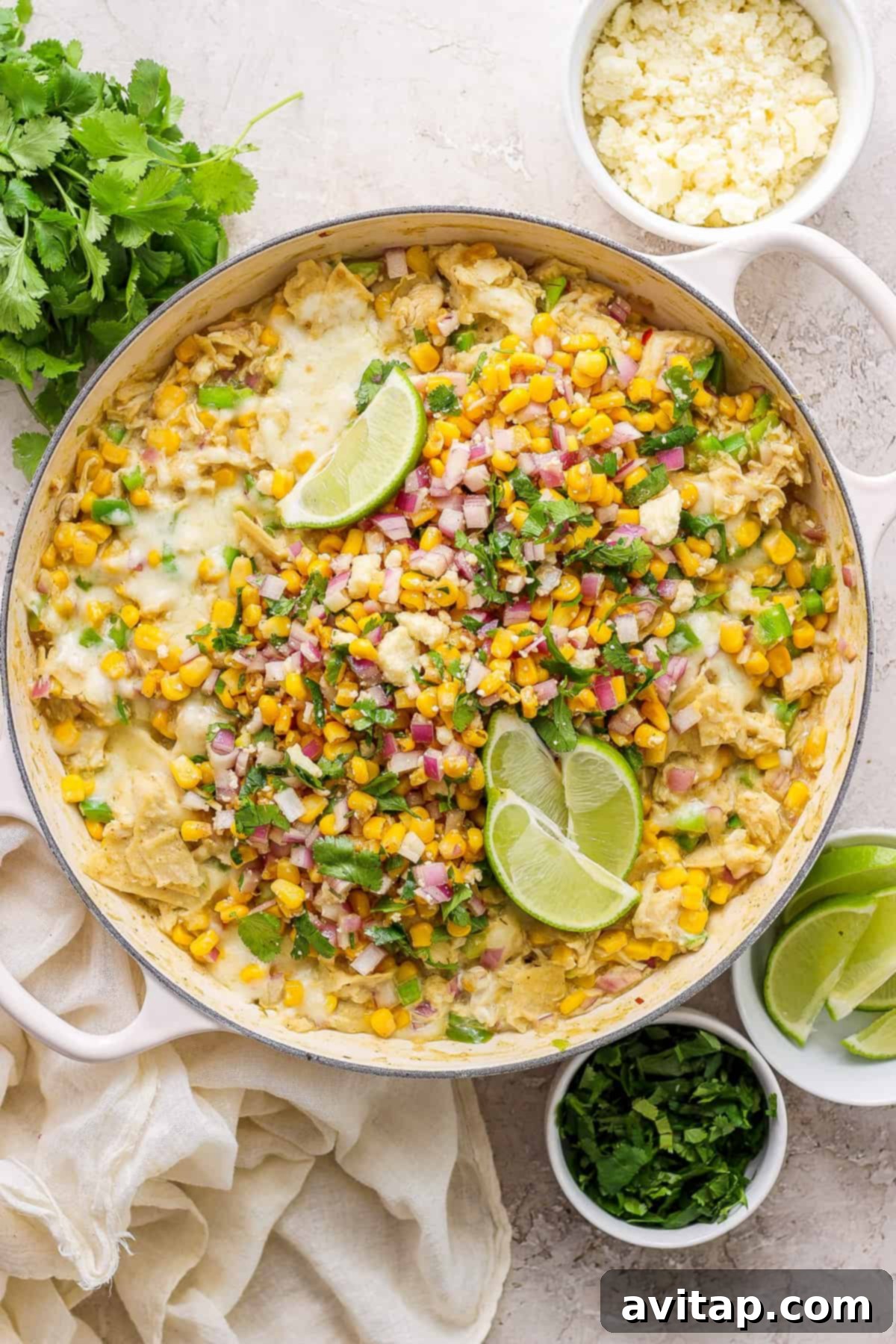 Mexican corn enchiladas in a skillet, showcasing a golden-brown, bubbly top.