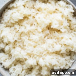 Fluffy sticky rice mixed with onions and nori in a bowl.