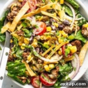 Fresh Prep Taco Bowl 10 A vibrant taco salad with ground meat, mixed greens, tomatoes, cheese, corn, black beans, and crispy tortilla strips, served with a creamy dressing on the side.