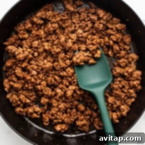 Fresh Prep Taco Bowl 8 Cooked ground beef seasoned with taco spices in a black skillet.