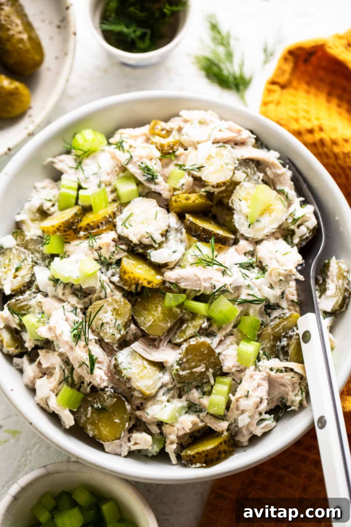 Tangy Dill Pickle Chicken Salad 2 Dill pickle chicken salad garnished with fresh dill in a serving dish, ready to be enjoyed.