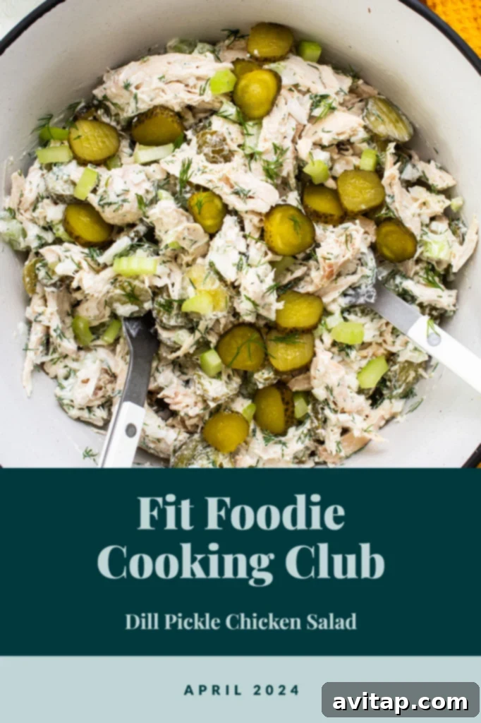 A vibrant bowl of dill pickle chicken salad, garnished with fresh dill and pickle slices, perfect for the Fit Foodie Cooking Club April 2024 challenge.