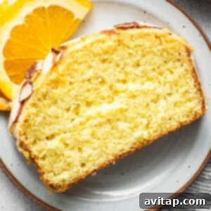 Orange Olive Oil Cake 5 A slice of orange pound cake on a plate, showcasing a similar citrus dessert option.