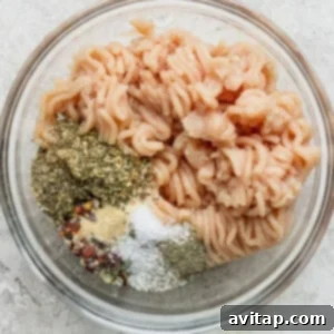 Cooked pasta with a variety of spices in a glass bowl.