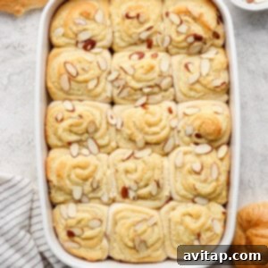 Baked cinnamon rolls fresh out of the oven, golden brown and puffed.