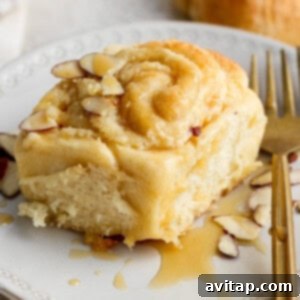 Glazed cinnamon rolls cooling in a baking dish.