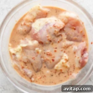 Marinated chicken thighs ready for grilling.