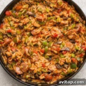A skillet filled with perfectly cooked orzo and vegetables.