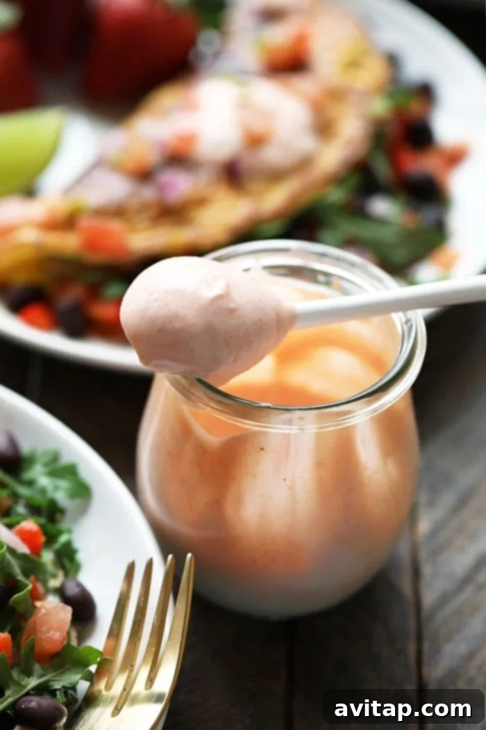 A jar filled with a creamy, spicy omelette sauce, ready to be drizzled over a fresh omelette.