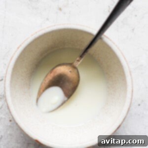 Melting white chocolate chips with coconut oil in a bowl.