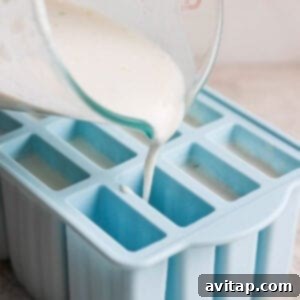 Pouring the coconut key lime mixture into popsicle molds.