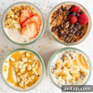 Top-down view of four jars filled with different flavors of overnight oats, garnished with toppings like strawberries, chocolate, raspberries, nuts, and coconut flakes, arranged in a 2x2 grid.