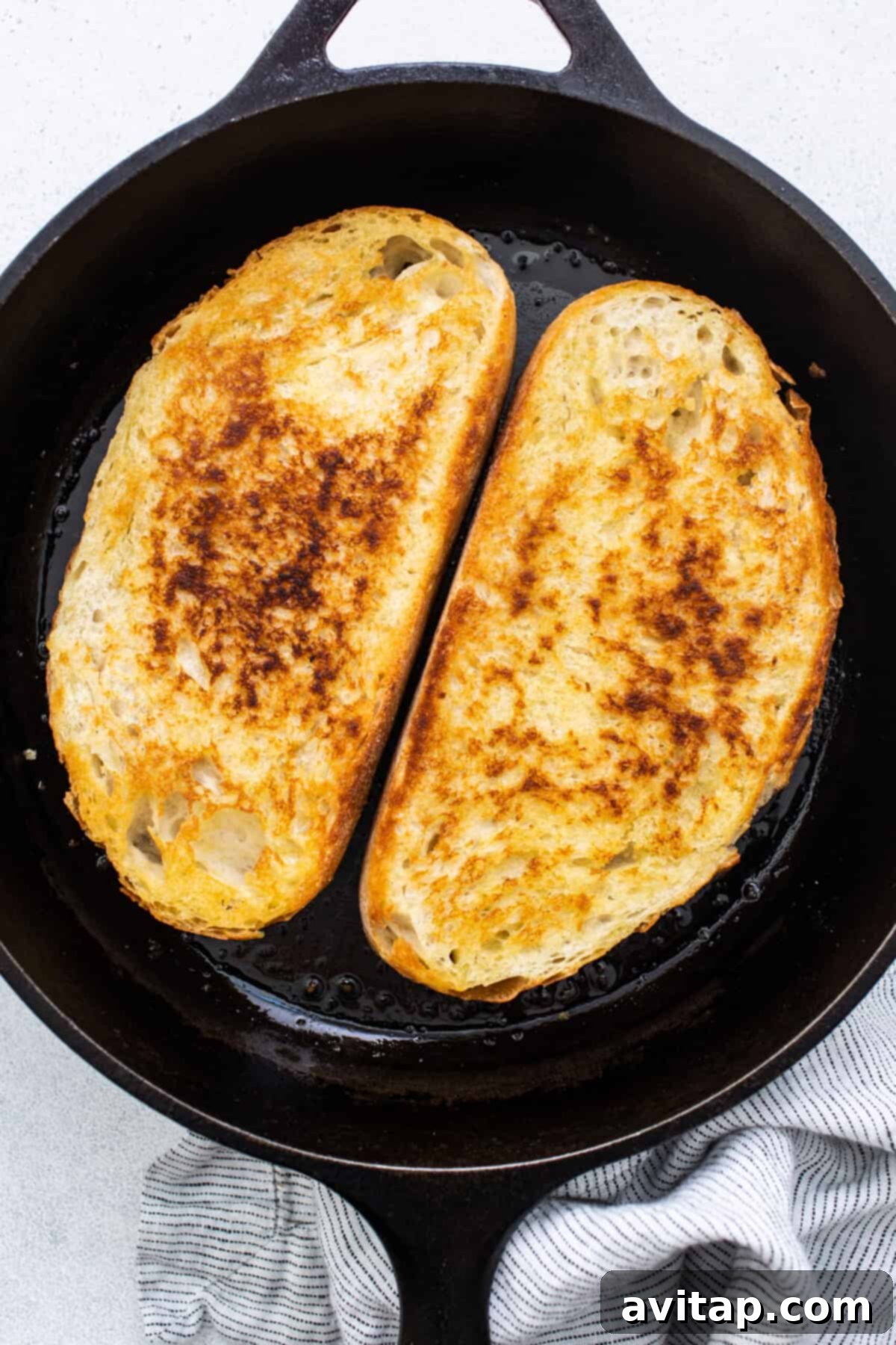 Thick slices of artisan bread lightly toasted to a golden brown perfection, ready to be topped with the flavorful bean mixture.