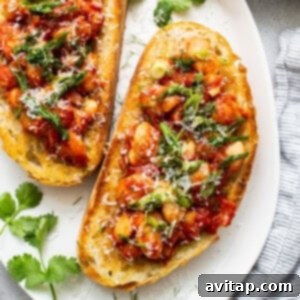 A close-up of gourmet chickpea and tomato bruschetta, illustrating the vibrant freshness and exquisite presentation of the dish.