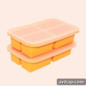 A stack of orange ice cube trays on a beige background, similar to a silicone mini loaf pan.