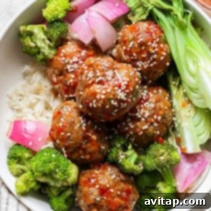 A bowl contains rice, sweet chili garlic meatballs with sesame seeds, broccoli, red onion, and bok choy.