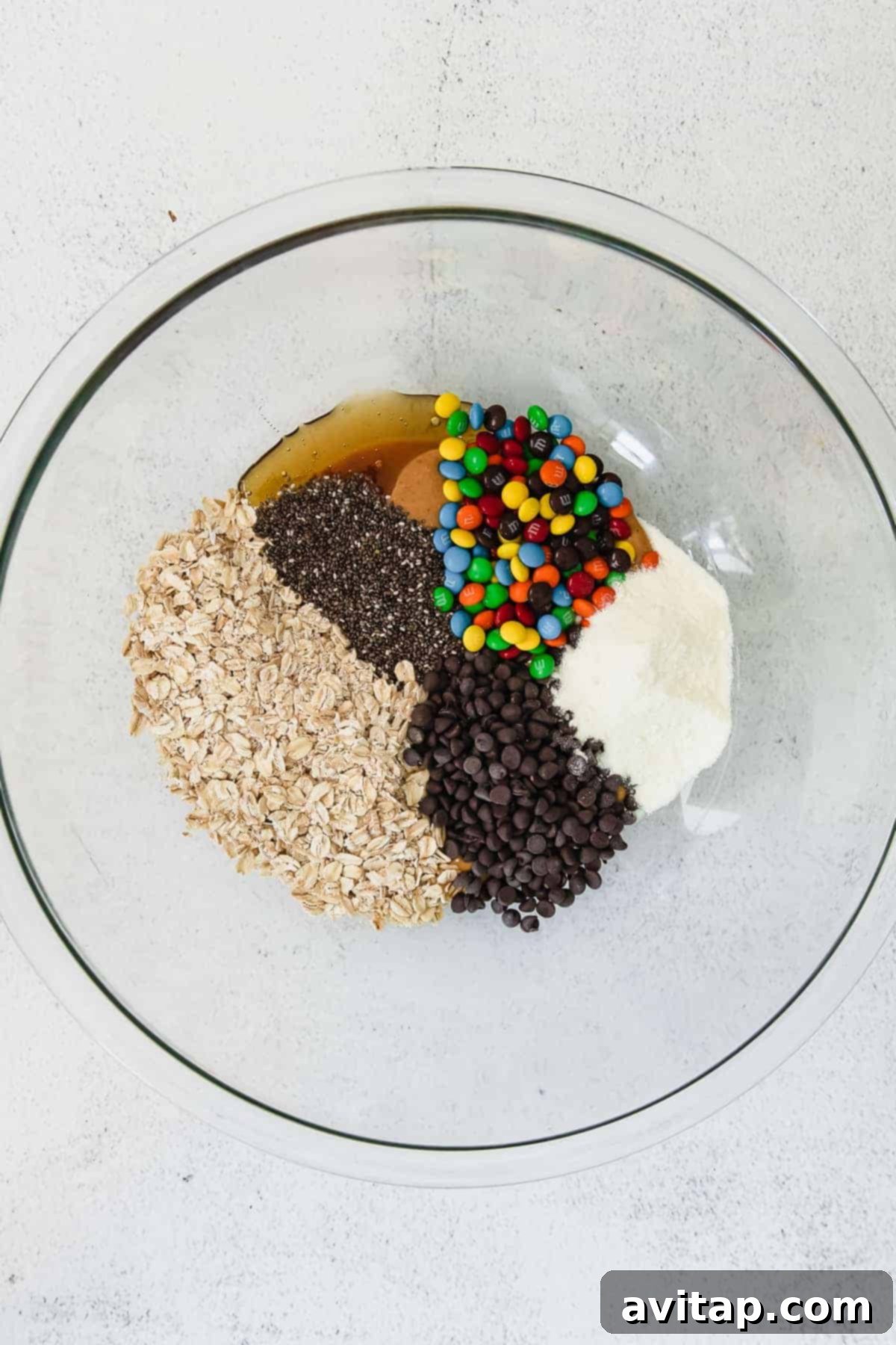 Oats, chocolate chips, marshmallows and chocolate chips in a bowl.