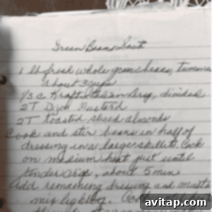 Handwritten recipe for a green bean saute salad on lined paper, featuring fresh green beans, Italian dressing, Dijon mustard, and toasted sliced almonds. The easy-to-follow instructions guide you through creating this crisp and flavorful dish.