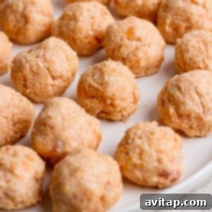 Sticky Sesame Ginger Salmon Meatballs 11 A plate of uncooked salmon balls arranged in rows on a white surface.