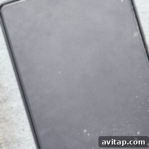 A rectangular, empty baking tray covered with a light dusting of flour on a textured surface.