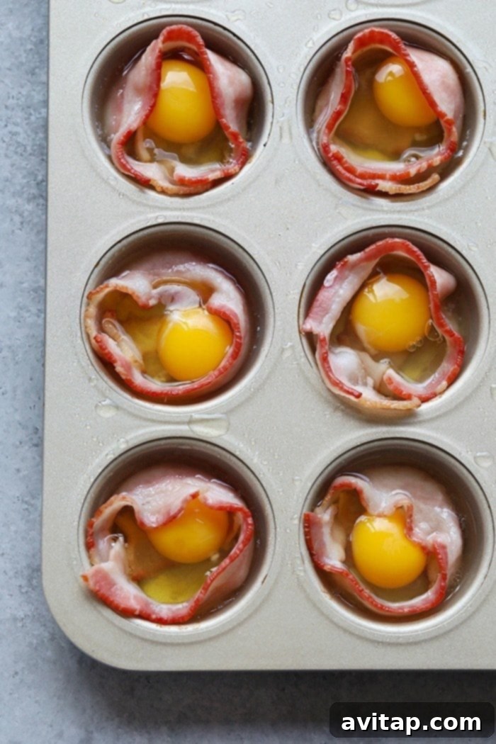 cracking raw eggs into the middle of bacon