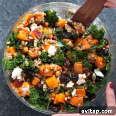 A colorful and robust farro salad served in an elegant bowl, featuring perfectly cooked farro, vibrant kale, tender roasted butternut squash, and other fresh, wholesome ingredients. This image highlights a healthy, hearty, and visually appealing option for a meal or side dish.