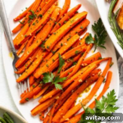 A vibrant serving of glossy garlic glazed carrots, perfectly tender and glistening with a savory sheen, invitingly ready to be enjoyed as a savory-sweet side dish. The colors are rich and appealing.