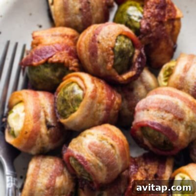 Delightfully crispy bacon-wrapped Brussels sprouts, artfully arranged on a pristine white plate, showcasing a tantalizing and irresistible appetizer or side dish. The golden-brown bacon contrasts beautifully with the green sprouts.
