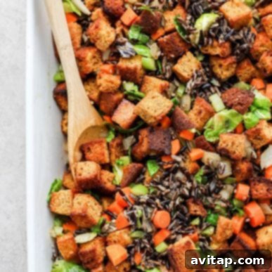 A generous portion of homemade cornbread dressing, elegantly served in a rustic bowl, beautifully showcasing its rich, comforting texture and savory, wholesome ingredients. This dish promises a true taste of tradition.