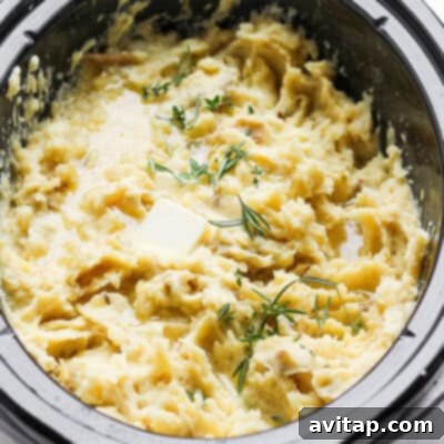 A hearty and comforting serving of mashed potatoes, simmering to absolute perfection within a crockpot, promising an effortlessly creamy and utterly delicious side dish that's ideal for a large gathering.