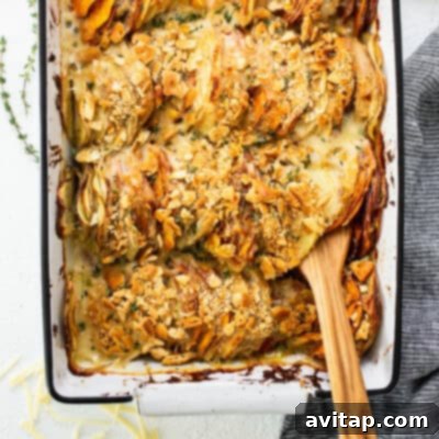 A rustic yet elegant baking dish generously filled with golden-brown roasted potatoes, accompanied by a finely crafted wooden serving spoon, invitingly ready to be enjoyed as a savory and comforting side.