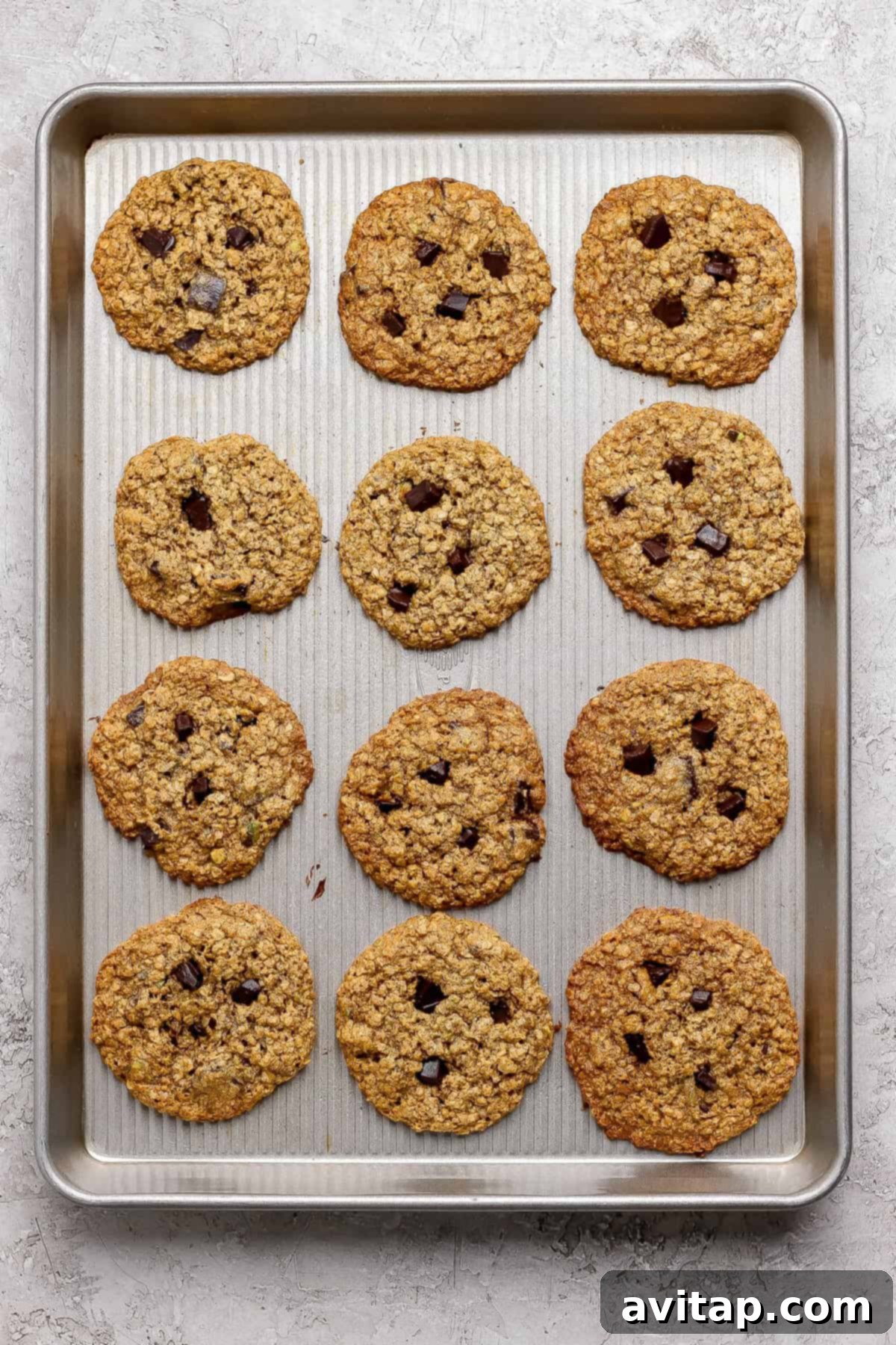 Chocolate Pistachio Dream Cookies 6 Baked oatmeal chocolate chip cookies on a baking sheet.